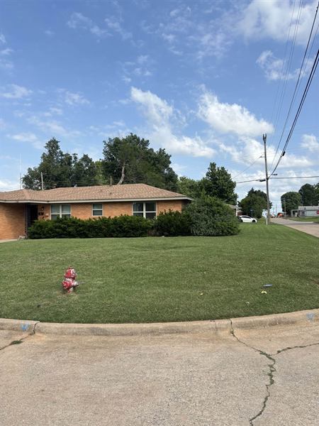 Corner lot with a freshly mowed lawn and trimmed hedge